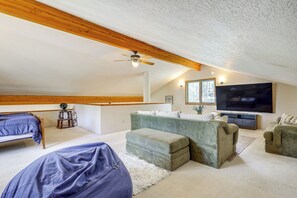 Relax in this stylish loft-style room with a high ceiling, flat-screen TV, and comfortable seating area.