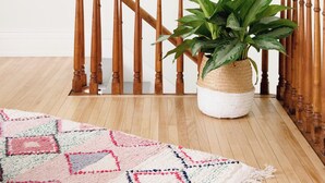 A wooden staircase with a woven basket containing a green plant. - The Ferg Heritage Suite | Picton | 2 Bedrooms (Prince Edward)