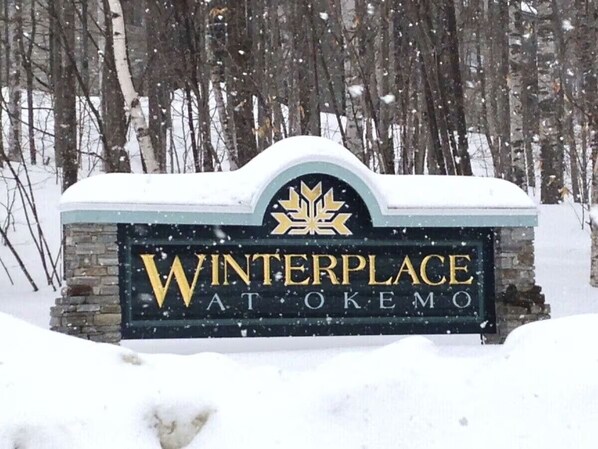 A sign for Winterplace at Okemo with a maple leaf logo. - Okemo Ski in-Ski out @ Winterplace, 3 bdr, 2 ba Condo with Pool, Hot Tub, W/D (Ludlow)