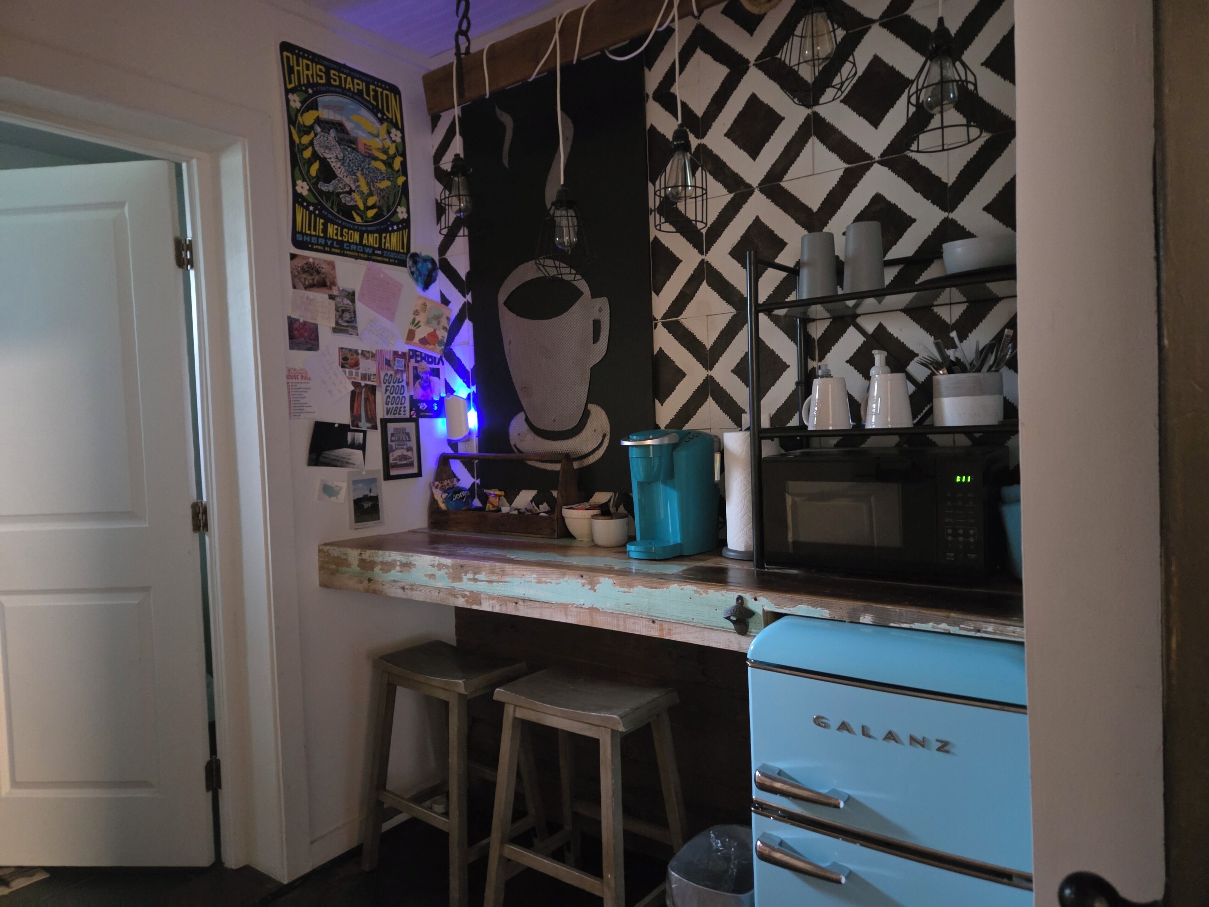 A kitchen with a vintage Galanz refrigerator, a microwave, and a coffee maker on the counter.