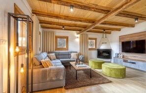 Relax in this inviting space with a comfortable sofa, fireplace, and flat-screen TV.