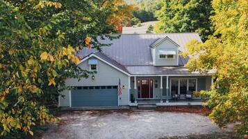 A house with a garage, a porch, and a driveway.