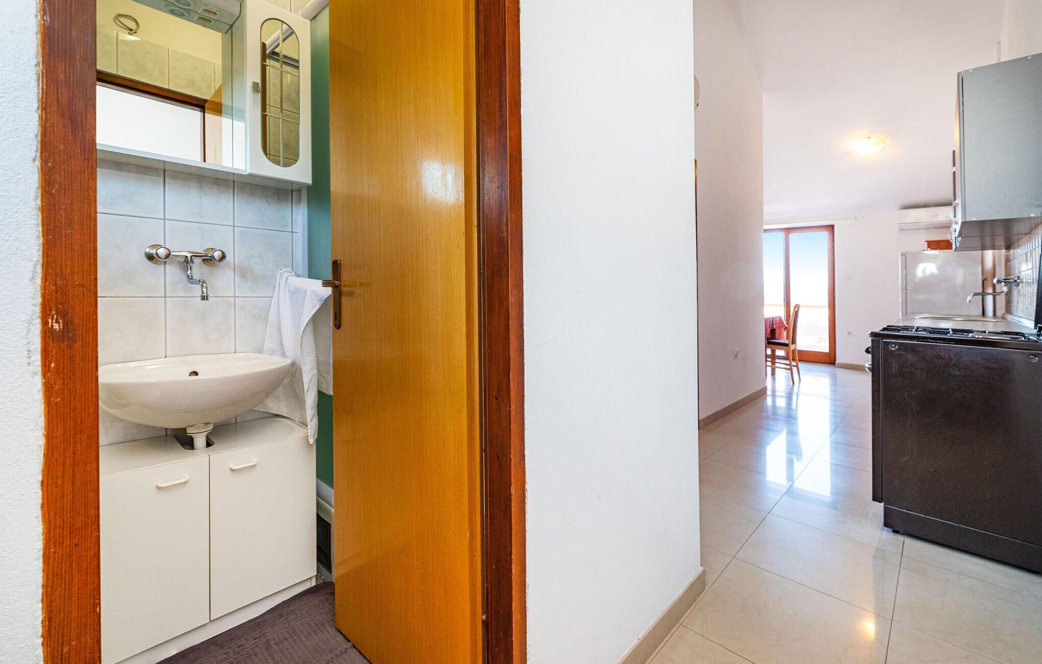A modern bathroom with a sink, mirror, and cabinets.
