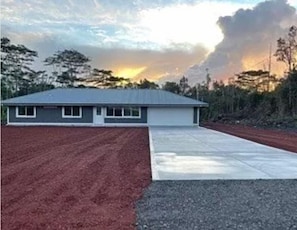 Set amidst a serene lawn, this single-story home offers a simple, functional design and an entrance.