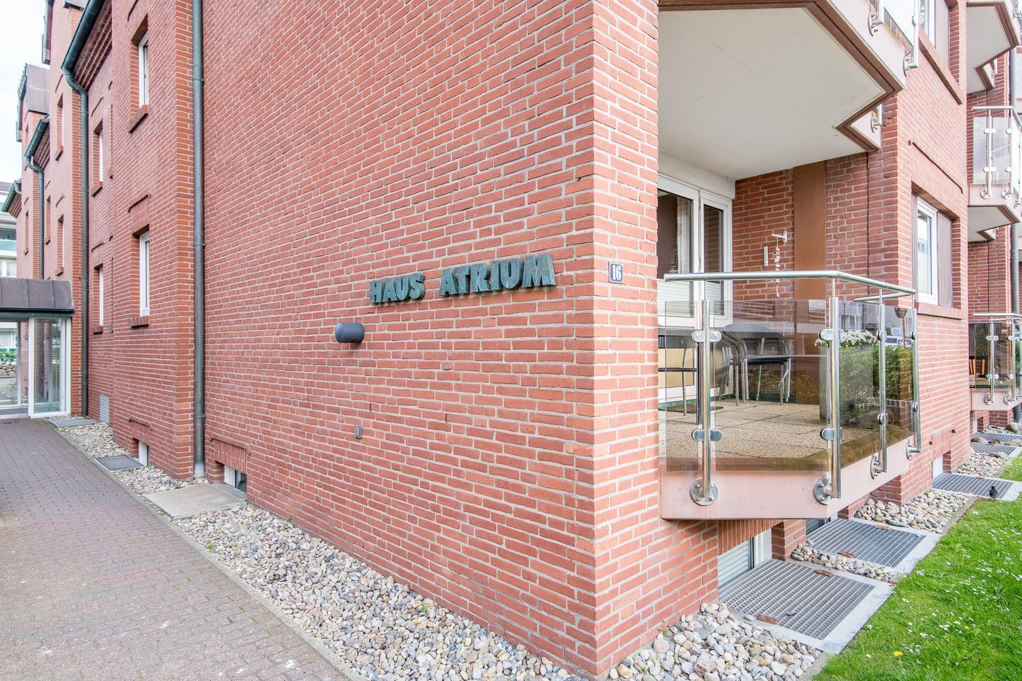 A red brick building with a sign reading "HAUS ATRIUM".
