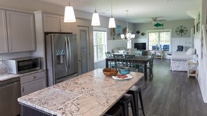 A modern kitchen with granite countertops, stainless steel appliances, and pendant lighting. - Dockside - Picture Perfect Home - Gorgeous Views! (Arapahoe)