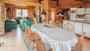 A cozy log cabin interior with a dining area, kitchen, and living space. - 3 bedroom stunning home in Samsø (Samsø)