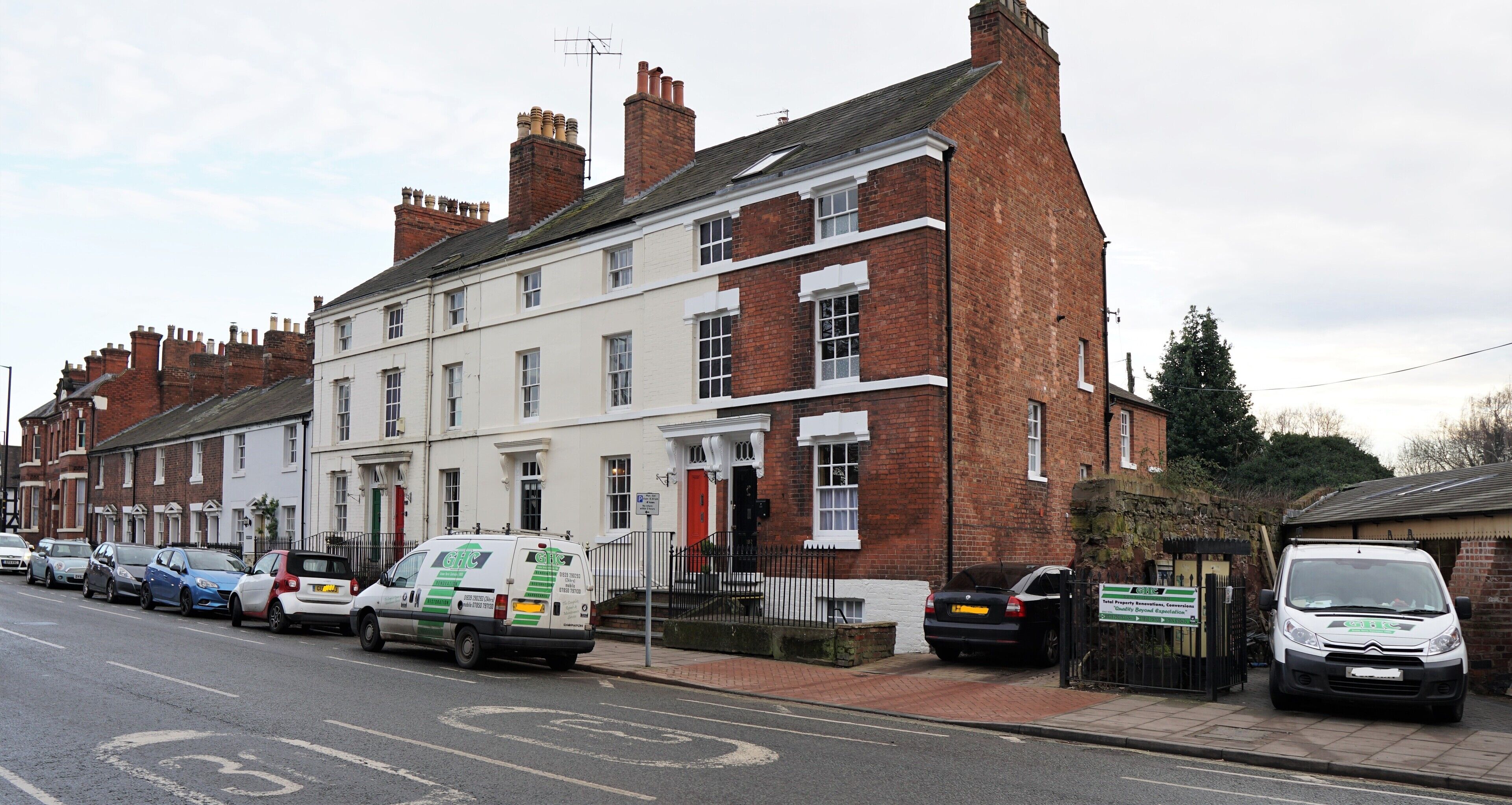 A row of terraced houses with a white van parked in front.