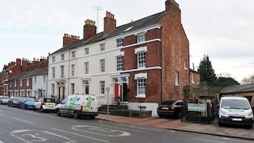 A row of terraced houses with a white van parked in front.