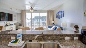 A modern kitchen with granite countertops, a double sink, and a ceiling fan. - 2 Bedroom in Shores of Panama - Same floor reserved parking and stunning views! (Panama City)