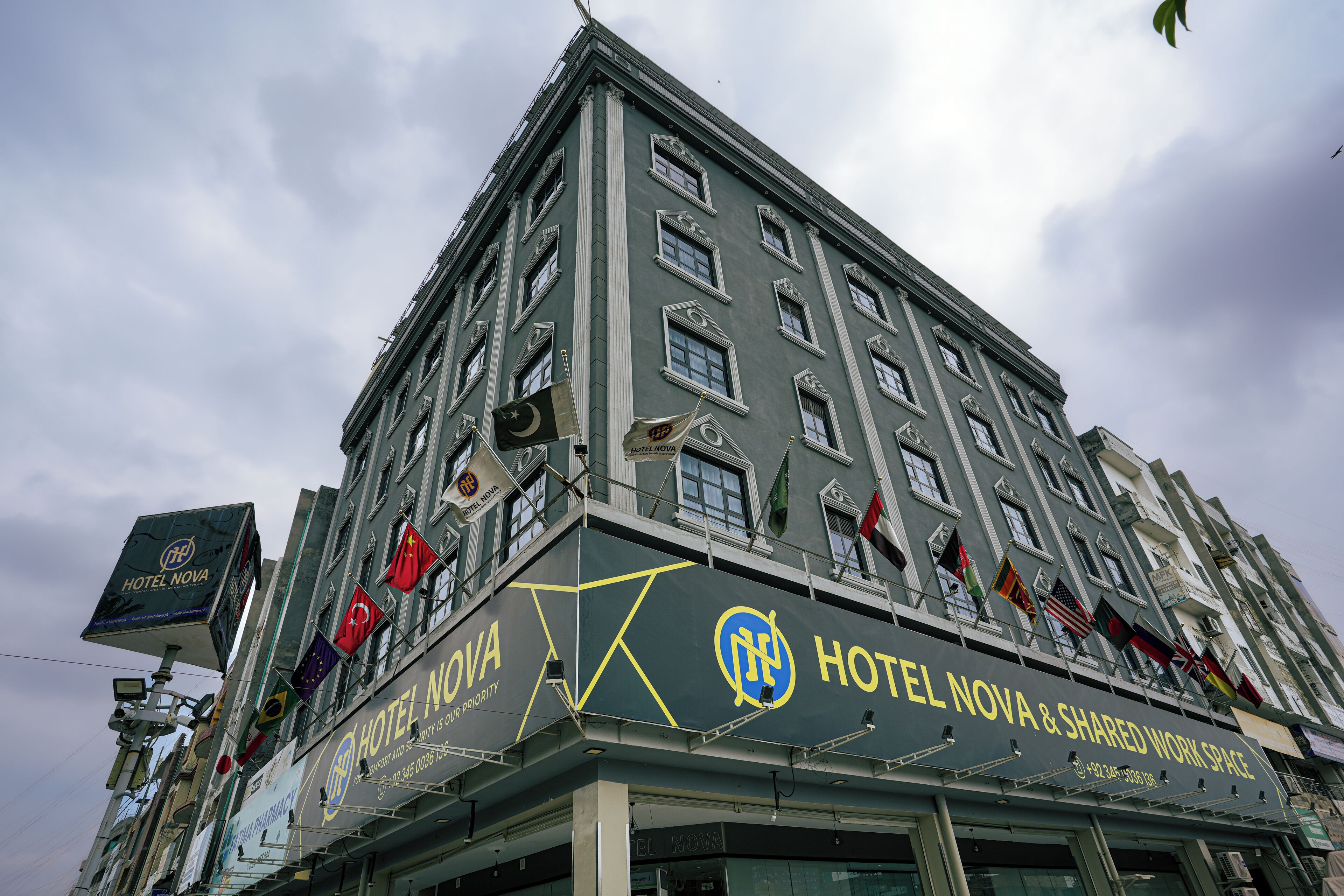 A multi-story building with a sign for Hotel Nova & Shared Work Space.