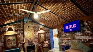 A cozy room with a brick ceiling, a bed, a sofa, a TV displaying 'NETFLIX', and a patterned rug. - Casita. W PRIVATE POOL (Ajijic)