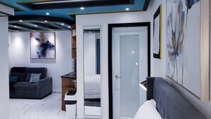 Un intérieur moderne comprenant un canapé, un coin repas et une porte donnant sur une autre pièce.