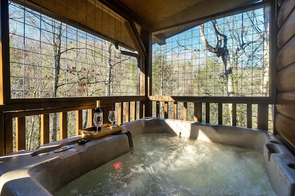 Feels like your own woods retreat with a hot tub on the porch