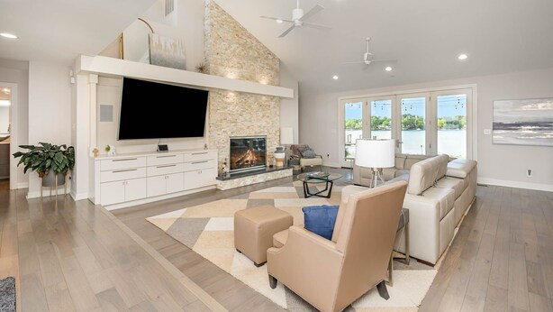 A spacious living room with a fireplace, a flat-screen TV, and a comfortable seating area.