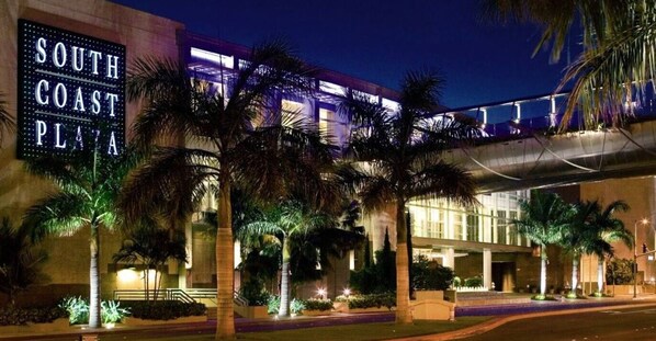 A hotel with a prominent sign reading "South Coast Plaza" and a covered walkway.