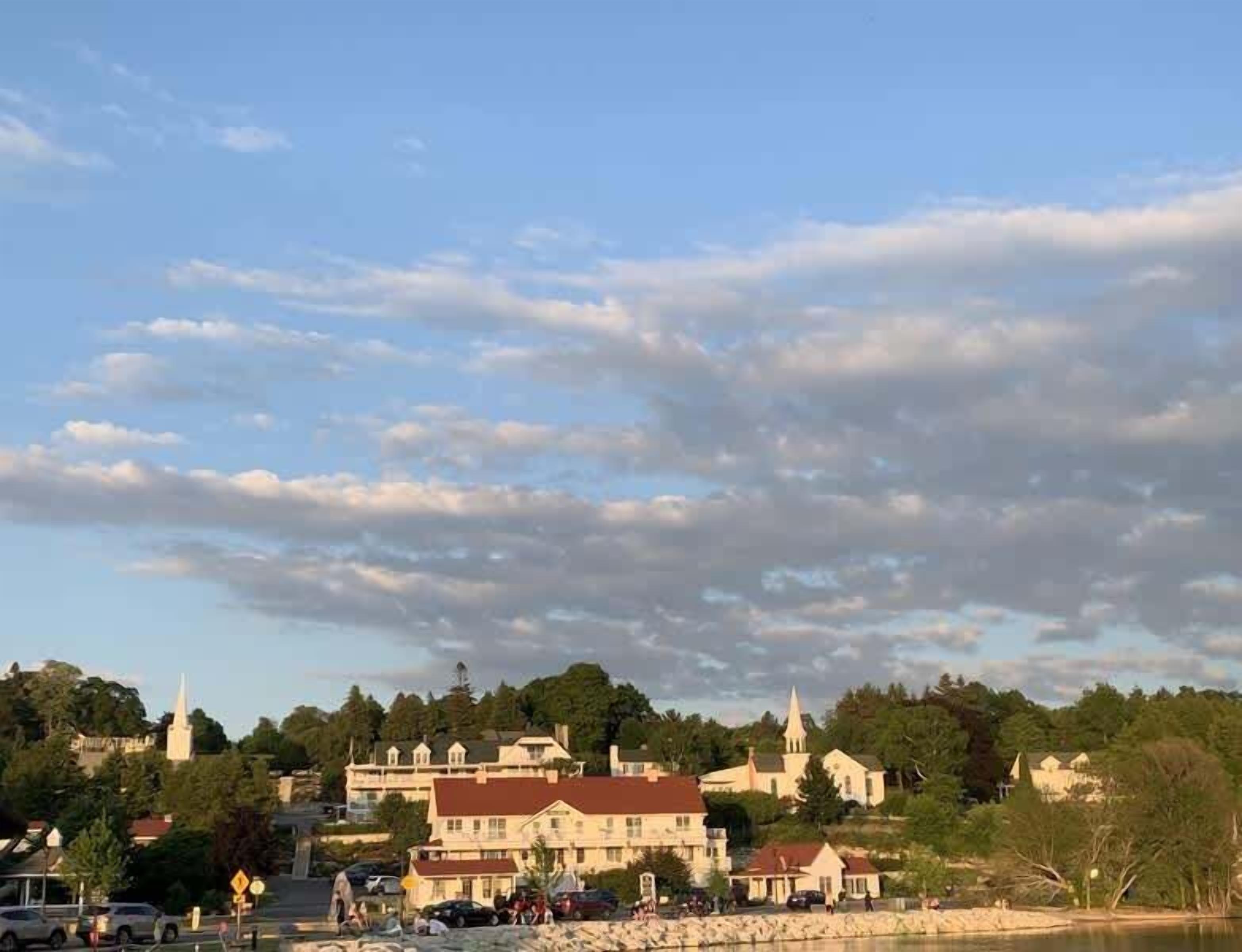 A town with historic buildings, a church, and a waterfront.