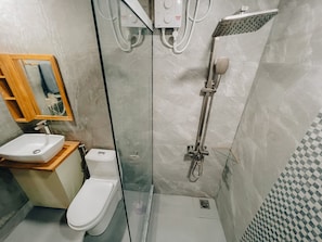 A modern bathroom with a toilet, sink, and shower. - Mahchavaru Maldives (Mathiveri)