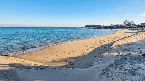 A sandy beach with a clear blue sky and calm sea. - 3 bedroom nice home in Les Portes-en-Ré (Les Portes-en-Ré)