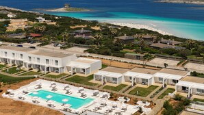 An aerial view of a resort with a swimming pool, beach, and ocean. - Capo Falcone B. Premium, Stintino, Italy (Stintino)