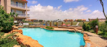 First-floor condo near Whitecap Beach with balcony, pool & dock