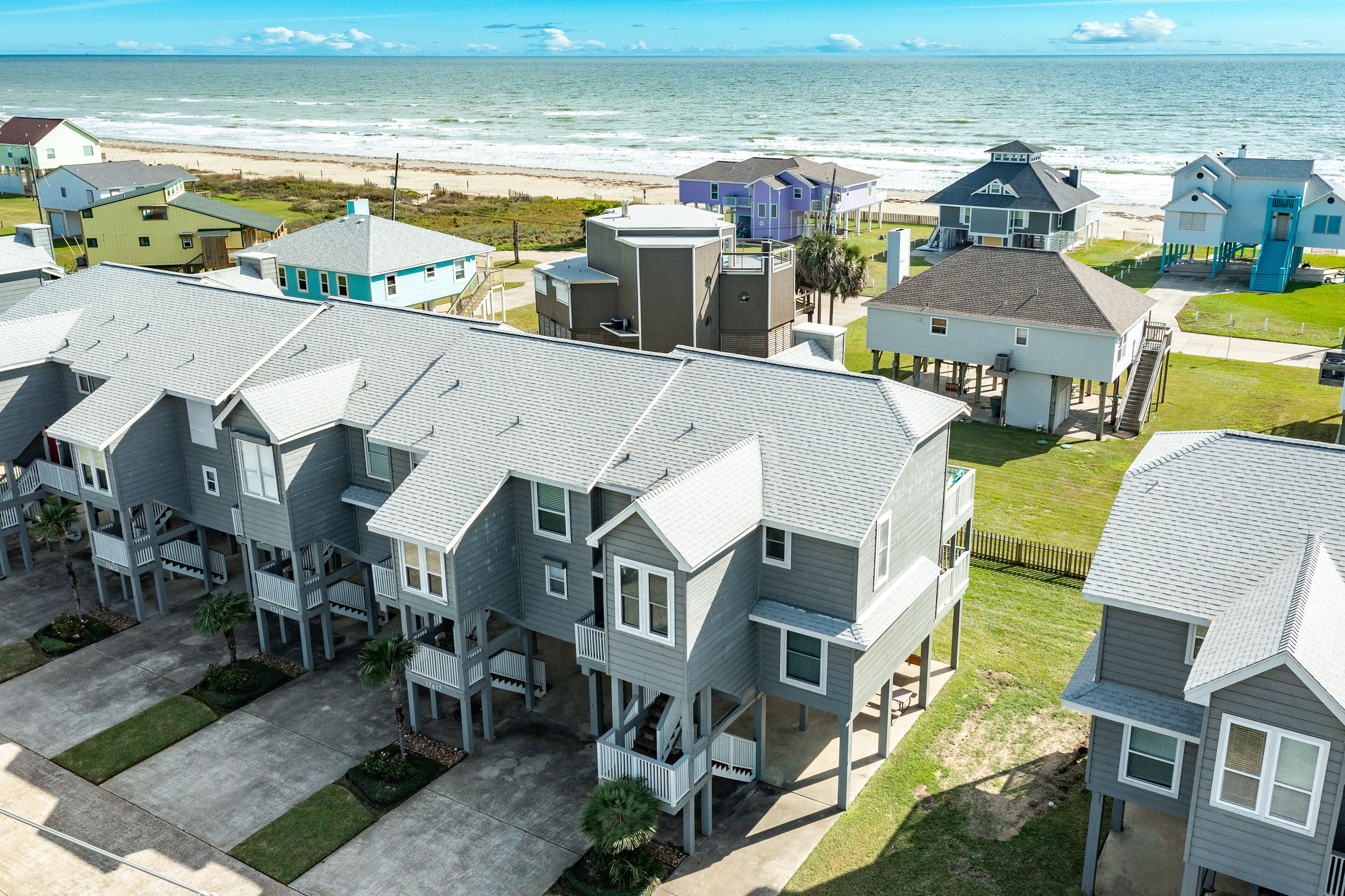 Bright blue ocean-view home with private balconies, washer/dryer, and central AC