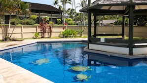 A swimming pool with two sea turtles, surrounded by a landscaped garden and a gazebo. - Hale Kuilima: Condo on the Golf Course at Turtle Bay (Kahuku)