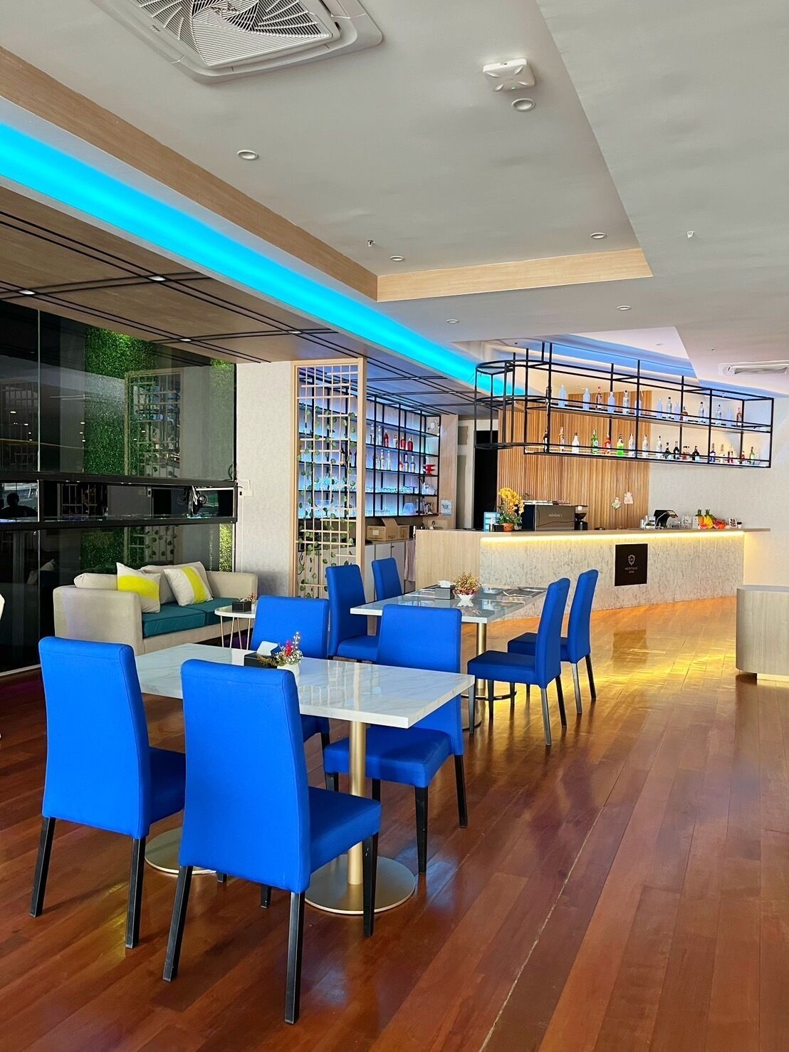 A modern interior with a dining area, bar, and seating with a view of the outdoors.