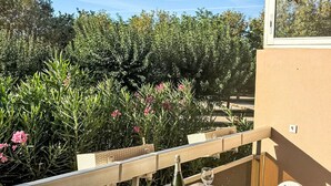 A balcony with a view of dense greenery and a clear sky. - L'Alicastre by Interhome (Le Lavandou)