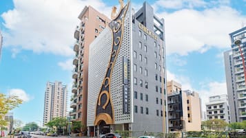 Welcome to our hotel, featuring a striking entrance with a large archway and modern design.