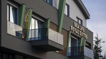 A modern building with balconies and a sign reading "Sea Life Royal Suites".