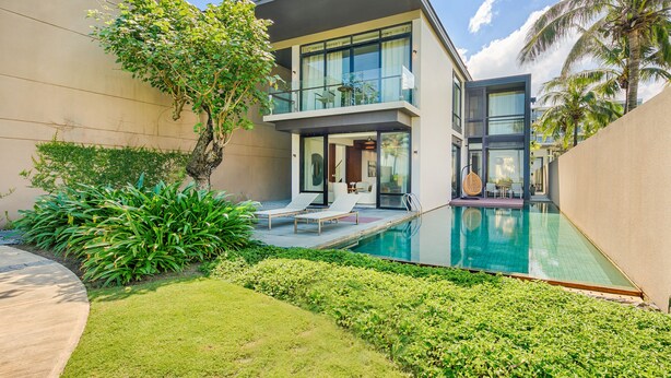 A modern two-story house with a swimming pool, a balcony, and lush greenery. - Abogo Resort Villas Beachview Da Nang   (Da Nang)