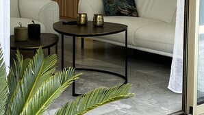 A modern living room with a sofa, coffee table, and decorative items.