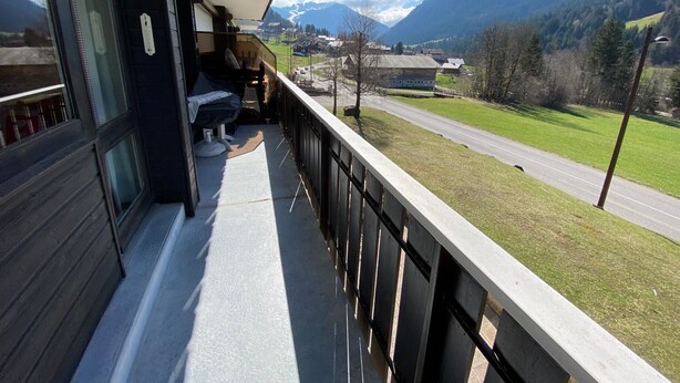 Ein Balkon mit Blick auf eine Straße und Berge.