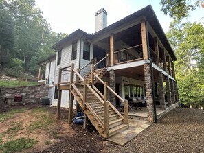 Enjoy outdoor dining on the covered porch with a table and chairs.