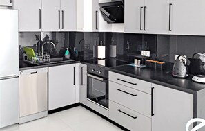 Fridge, stovetop, dishwasher, coffee/tea maker