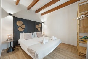 A bedroom with a large bed, a wooden ceiling, a wall-mounted shelf, and a bedside table. - Vacation Home 'Sa Figuereta Living Place' with Mountain Views, Wi-Fi & Air Conditioning (ARIANY)