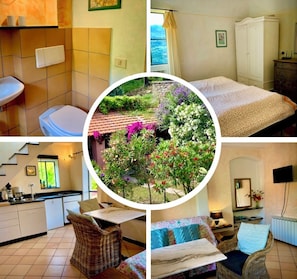 A hotel room with a bed, a bathroom, a kitchen, and a view of a garden.