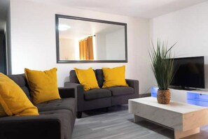 Relax in this stylish living room with a sofa, flat-screen TV, and coffee table.