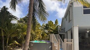 A house with a pool, surrounded by palm trees. - SOUTHERN SUNSET - As seen on House Hunters-S228 E6 - Family Time in the FL Keys (Cudjoe Key)