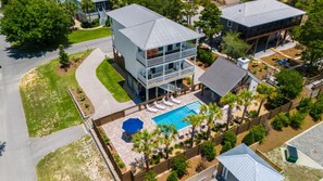 A two-story house with a large backyard, a swimming pool, and a covered patio area. - HUGE Private Pool w/ 6 seater Cart 4 bikes, 4 min to Beach, 3 hole Putting Green (Santa Rosa Beach)