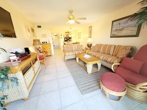 A living room with a sofa, armchairs, a coffee table, and a dining area with a table and chairs. - SH 149.Ocean View Townhouse with great pool and ocean view. (St. Augustine)