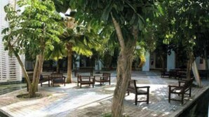 A courtyard with benches and trees, surrounded by buildings. - O' calme studio accommodation paradise sea view (Saint François)