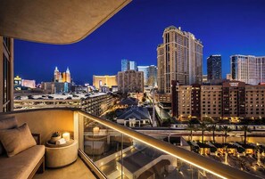 A high-rise hotel room with a city view, a balcony, and a seating area. - MGM Signature Tower 2 | 8th Floor 2-Suite | Strip View Balcony | No Resort Fee (LAS VEGAS)