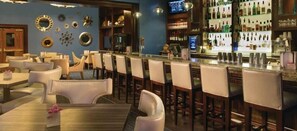A bar area with multiple seating options, including bar stools and tables, and a well-stocked bar counter. - MGM Signature Tower 2 | 8th Floor 2-Suite | Strip View Balcony | No Resort Fee (LAS VEGAS)