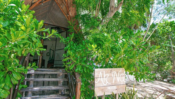 A wooden staircase leading to a building with a sign reading "Ar Na Hotel". - Hotel Ak'Na Holbox (Isla Holbox)