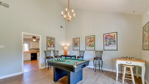 A spacious room with a pool table, a foosball table, and a bar area. - Peaceful Millington Home ~ 13 Mi to Memphis! (Millington)