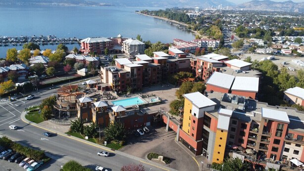 A multi-story hotel with a pool, located near a waterfront. - Playa Del Sol Retreat 550 | Pool + Hot Tub | (Kelowna)