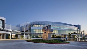 A modern hospital building with a large sculpture in the center, surrounded by a landscaped area. - Airy Arty Studio with Amenities (Gardena)