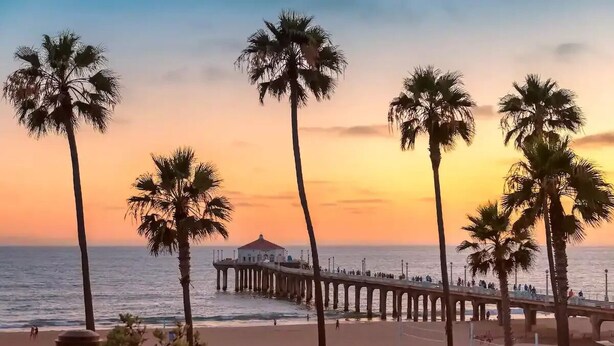 A beach scene with palm trees, a pier, and a gazebo. - Airy Arty Studio with Amenities (Gardena)